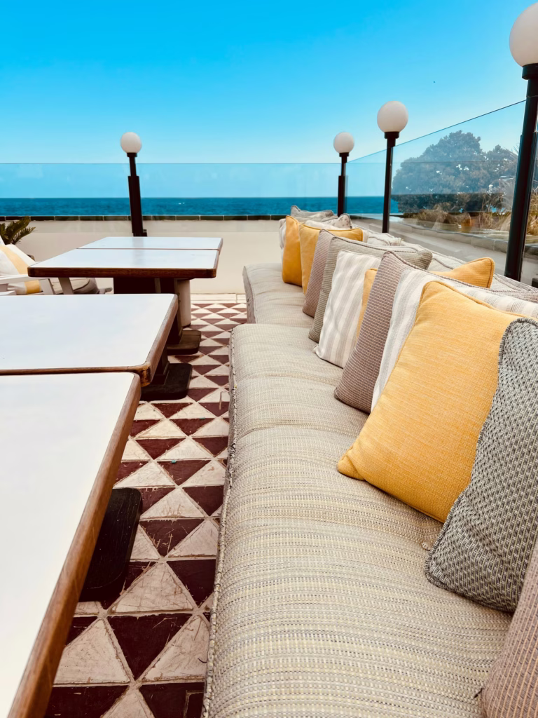 Residence terrace seating with cushions facing the ocean